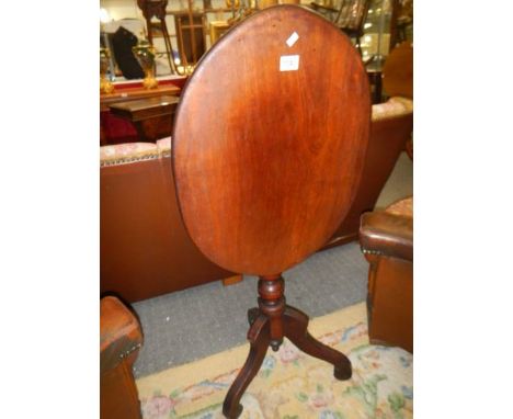 An oval mahogany tripod table. COLLECT ONLY.