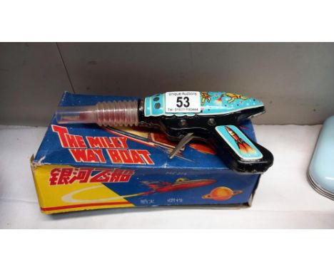 A boxed tinplate The Milky Way boat MF215, made in China and a vintage space gun