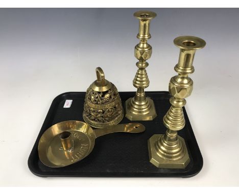 A pair of Victorian brass candlesticks, 29 cm together with a brass bell and a brass candlestick