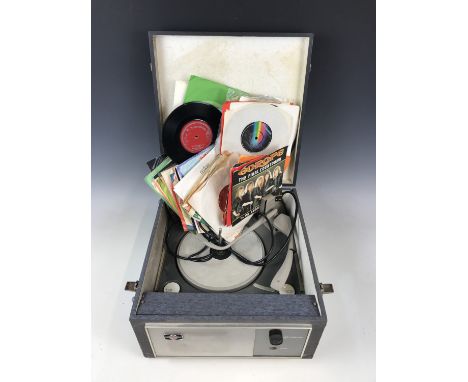 A vintage Pye record player together with a quantity of singles