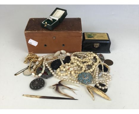 A quantity of vintage costume jewellery in a leather box, including an early "Fiji" souvenir brooch, and a mother of pearl sw