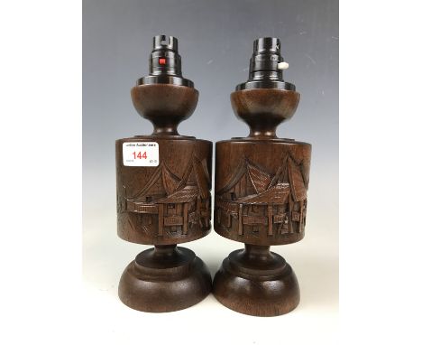 A pair of oriental carved wood table lamp bases 