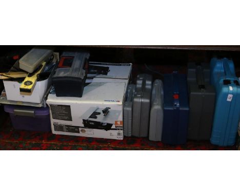 A collection of tools including cased power tools and boxed tile cutting saw.