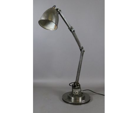 An industrial metal anglepoise desk lamp.