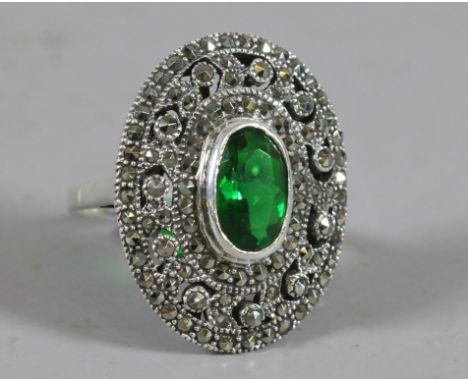 An Art Deco style ladies silver dress ring set with marcasites and a faceted green stone, size Q.