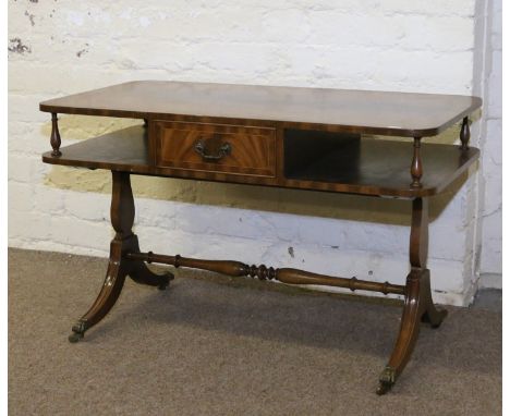 A Regency style mahogany two tier sofa table crossbanded and raised on carved sabre supports.