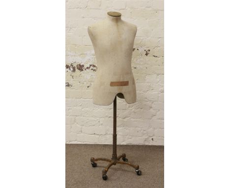 A vintage dressmakers mannequin on metal stand.