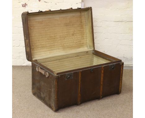 A large metal and wooden bound travel trunk.