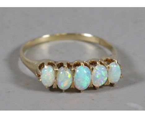 A ladies high carat gold five stone opal ring. UK size Q.