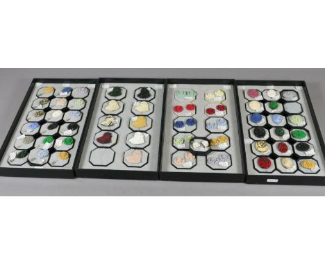 Four display trays of resin bonded earrings, brooches and stick pins etc.