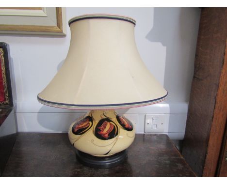A Moorcroft table lamp base, cream ground with Art Nouveau floral design, 40cm tall with shade