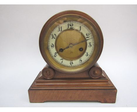 A late-19th Century walnut mantel clock by the Hamburg American Clock Company, with black Arabic numerals to the cream chapte