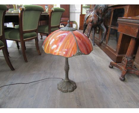 A reproduction Tiffany style table lamp with foliate relief base and stained glass domed shade, 70cm tall