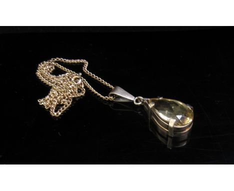A 9ct gold chain hung with a pear shaped citrine pendant, 52cm long, 8.4g                             