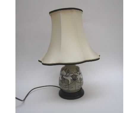 A Moorcroft table lamp base, grey ground with floral design, 43cm tall with shade 