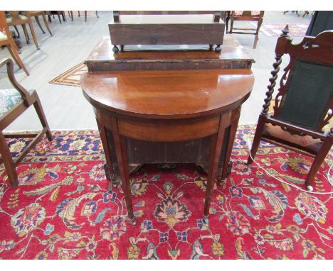 A Victorian mahogany demi lune card table, rosewood crossbanding, line inlay on square tapering legs to brass castors