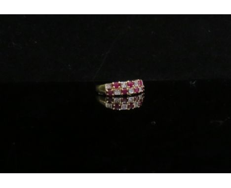 A 9ct gold ruby and diamond chequerboard half hoop ring. Size L/M, 2.3g       