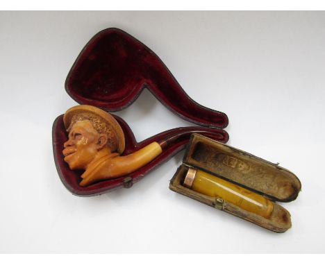 A 19th Century Meerschaum pipe the bowl carved as the head of a boy wearing a straw hat, with amber mouthpiece (slight scuffi