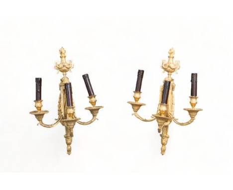 A pair of elegant Louis XVI 3-light wall sconces. The bracket shaped shaft is crowned with a fluted vase decorated with a gar
