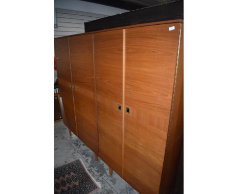 A pair of vintage teak wardobes, labelled Stonehill furniture, recessed handles, fittings to inside of one, mirror to the oth