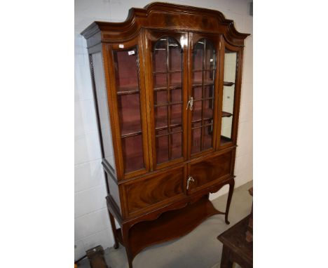 An Edwardian mahogany display cabinet having glazed section and cupboard under with cabriole legs and under shelf