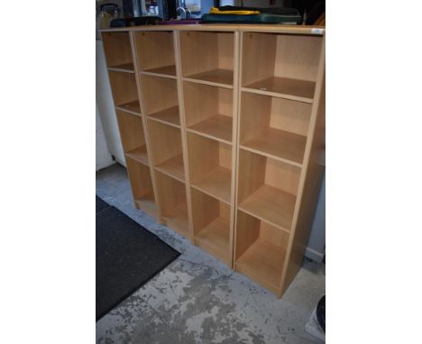 Four narrow laminate shelf units