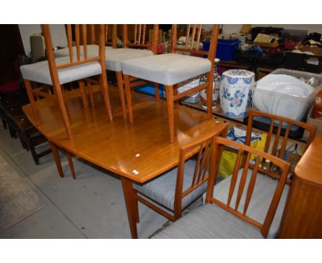 A vintage Gordon Russell dining table and eight chairs