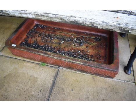 A glazed shallow trough