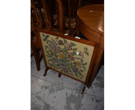 An early 20th Century stained frame fire screen having woolwork panel
