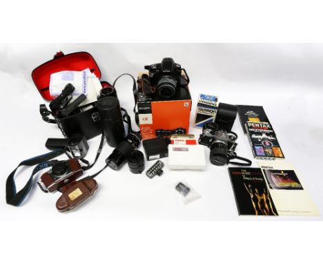 A Sony camera in case with a collection of accessories along with other cameras including vintage with accessories.