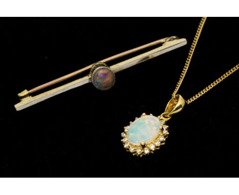 An opal and diamond 18ct gold pendant, comprising an oval opal within a border of round brilliant cut diamonds, 10mm (not inc