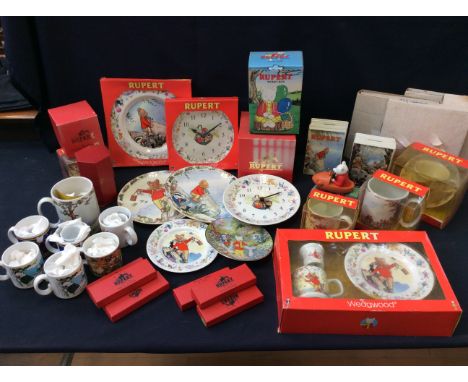 A collection of Rupert the bear Souvenirs to include ceramic plates, clocks, Money boxes, mugs,figures, silver plates spoons 