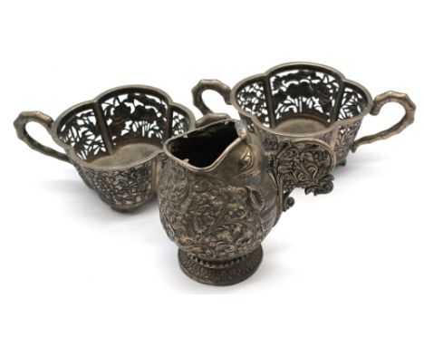 A pair of late 19th / early 20th century Chinese silver bowls / cellars, of flower shape with twin handles of bamboo design, 
