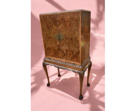 A mid 20th Century walnut veneer drinks cabinet with pull out mixing shelf, mahogany jardiniere stand and a collection of sma