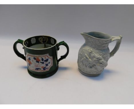 A 19th Century twin handled mug with green ground and Chinese detail, red mark to base, c1830 along with same period stonewar