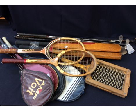 A collection of vintage tennis rackets, cricket bats and golf clubs.