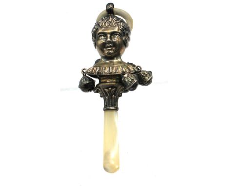 An early 20th century baby's silver and mother of pearl teething rattle with mother of pearl handle and teething ring, length