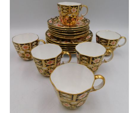 6 Royal Crown Derby trios in the 2451 pattern ,(coffee cups, saucers and tea plates). all in good overall condition. Usual fa