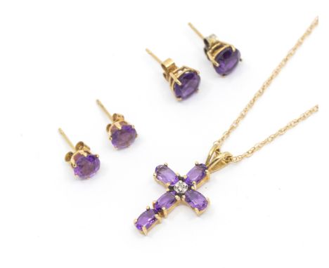 A collection of amethyst and 9ct gold jewellery including a cross and chain, two pairs of round mixed cut stud earrings, comb
