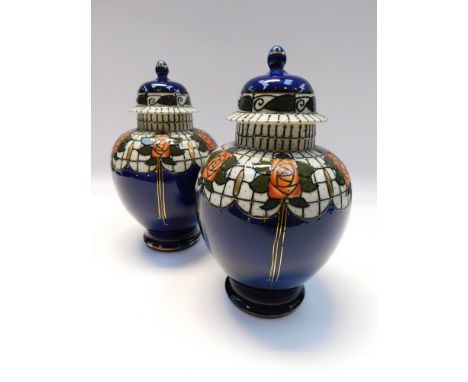 A pair of covered vases in the Trellis Design by Frederick Rhead for Wood &amp; Co , c.1915. One cover has finial broken and 
