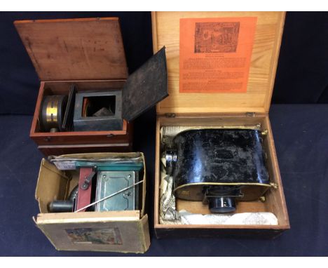 An early 20th Century boxed German tinplate and gilt Magic Lantern with slides, in original box with instructions together wi