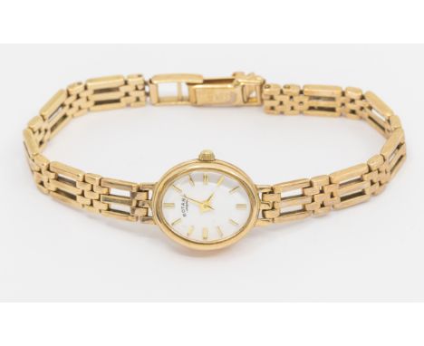 A ladies Rotary quartz 9ct gold bracelet watch, comprising a signed white oval dial with applied baton markers, hallmarked 37