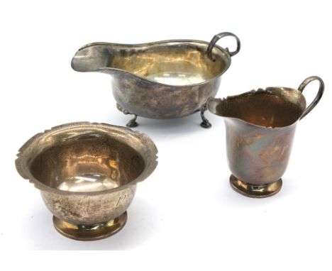 A George V silver sauceboat, upon three hoof feet with scrolled handle (misshapen), hallmarked by ES Barnsley, Birmingham, 19
