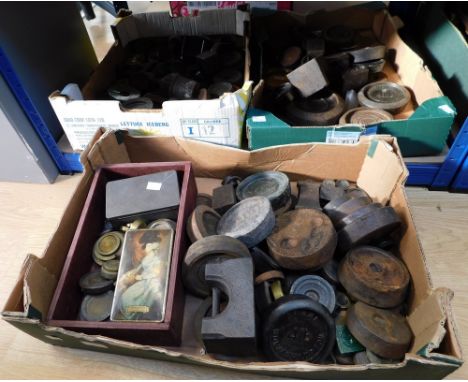 A large collection of iron weights for scales, all sizes.
