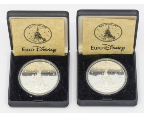 Two silver commemorative Euro Disney coins, dated 1992, 999/1000, both cased, combined weight approx 38.8gms&nbsp;