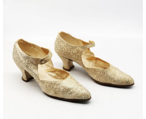 A pair of 1920s dance shoes with gold brocade finish, with strap and button fastening, louis heel and leather sole.  Further 