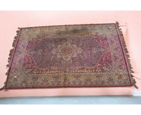A mid 20th Century machine made carpet, light red ground, some fading, foliage detail, 194cm x 126cm.