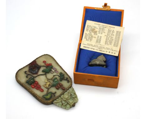 A 19th century Chinese hand held mirror (handle missing); the shaped bevelled mirror and dark green/celadon jade inset with v