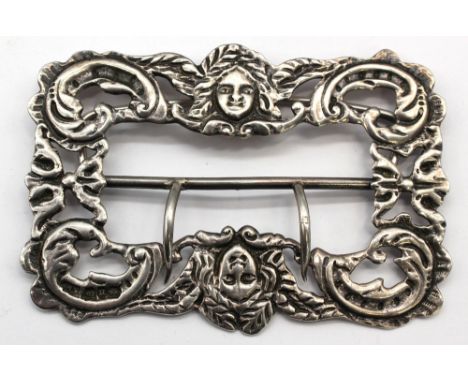 A late Victorian silver buckle, having elaborate scrolled design with two symetrical faces, hallmarked by William Neale, Birm