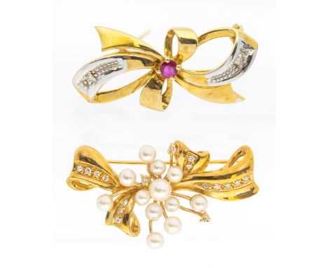 A two tone ruby and diamond set gold brooch, comprising a bow motif set to the centre with a round mixed cut ruby with diamon